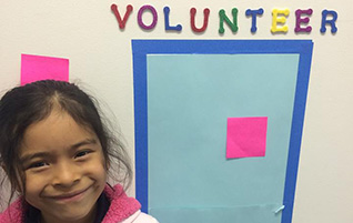 Child with volunteer sign